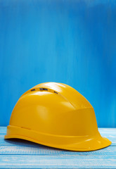 construction helmet on wooden table background