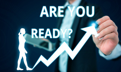 Fototapeta premium Conceptual hand writing showing Are You Ready Question. Concept meaning used telling someone start something when feel prepared Female human wear formal work suit presenting smart device