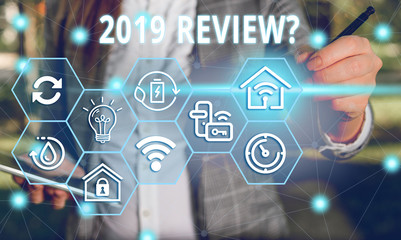 Word writing text 2019 Review Question. Business photo showcasing remembering past year events main actions or good shows Female human wear formal work suit presenting presentation use smart device