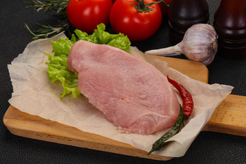 Raw Turkey steak served rosemary