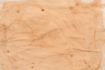 Blank brown aged paper sheet. Stained surface. Abstract art background. Copy space.