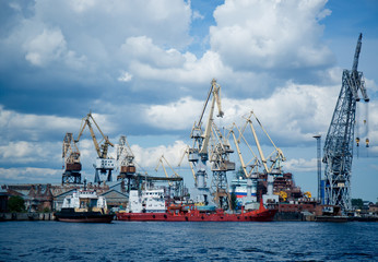 cargo port cranes against blue sky