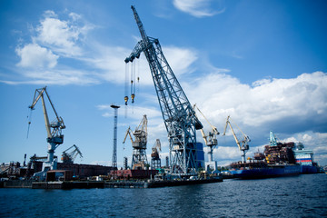Fototapeta na wymiar cargo cranes for unloading ships in the port