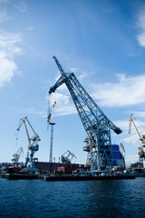cargo port cranes against blue sky