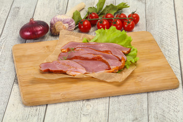 Sliced smoked duck breast served salad