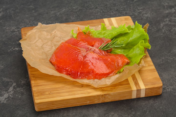 Sliced salmon fillet served rosemary