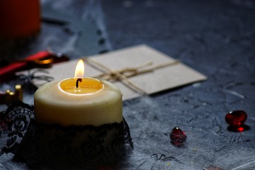Halloween vintage envelope with stamp. burning candles and spiders on the web next to a wooden cross. horizontal