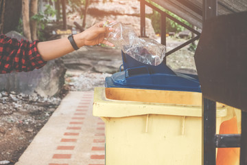 The volunteer picking put a bottle plastic into the tank for cleaning, volunteering concept. Environmental pollution and Ecological problem.