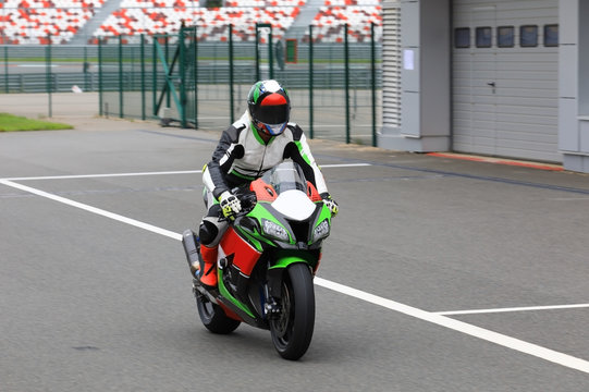 Motorcyclist on a racing motorcycle back to the pits