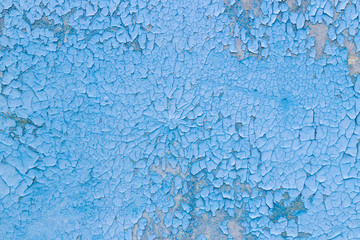 rough background for designers. The texture of the old cracked blue paint. Old broken paint on a concrete wall.