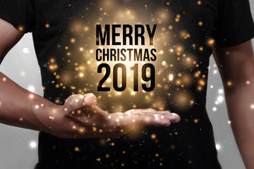 Hand showing Merry Christmas 2019.