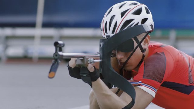 Portrait of Caucasian male professional biathlete practicing on a shooting range during mid-season practice in summer. ARRI Alexa Mini with Cooke S4 prime lenses RAW graded footage