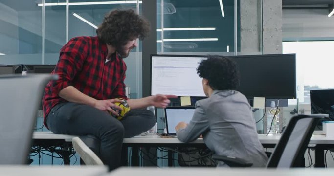 Young multiethnic business team of software developers working together using