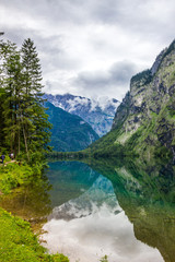 Plakat clouds over mountain lake Obersee in Alps