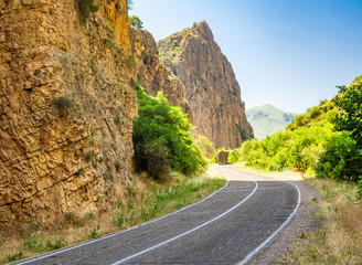 Asphalt road leading through gorge to Noravank monastery in Armenia