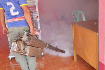 Man work spray fogging to eliminate mosquito for preventing spread dengue fever and zika virus