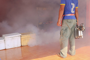 Man work spray fogging to eliminate mosquito for preventing spread dengue fever and zika virus