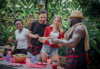 barbecue and party.Happy friends with barbecue party in nature