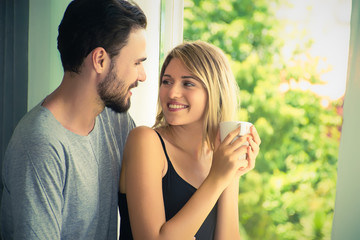 Obraz premium Cheerful young couple with coffee time in the morning at home.