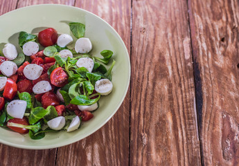 Fresh delicious tomatoes. With mozzarella cheese typical italian healthy cuisine culture.. Red tomatoes on a wood background.