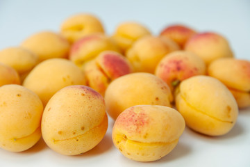 Ripe apricots fruit on white background