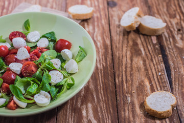 Fresh delicious tomatoes. With mozzarella cheese typical italian healthy cuisine culture.. Red tomatoes on a wood background.