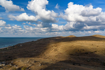 The beaches of the generals of the Crimean peninsula on a sleepy day with clouds in the sky, shot during the season of golden autumn yellow-golden brown.