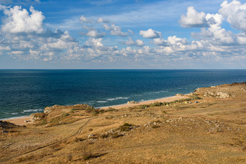 The beaches of the generals of the Crimean peninsula on a sleepy day with clouds in the sky, shot during the season of golden autumn yellow-golden brown.