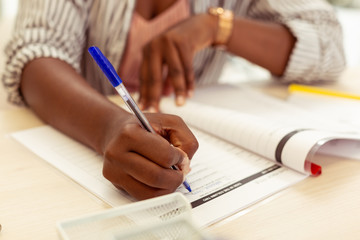 Clever international female person completing grammar task