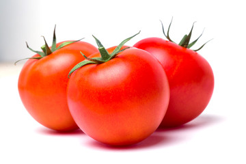 Three ripe red tomatoes on white isolate background, closeup