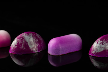 Set of chocolate bonbons on black background close-up