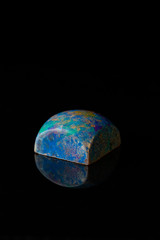 Chocolate bonbon on black background close-up