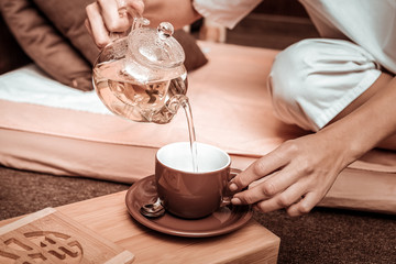 Woman pouring out tea before the tea ceremony.