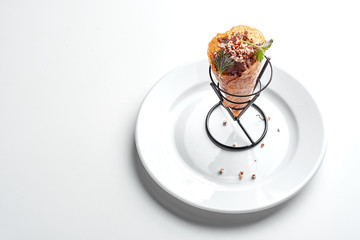 poultry pate served on a white plate in an ice cream cone