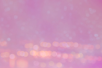 Abstract light bokeh on the pink glowing background