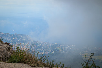 Magic view from the top of AI-Petri mountain in Crimea, Russia on high rocks of Crimean mountains, black sea coast and blue sky with clouds. High mountains view