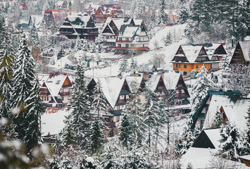 Small town village near Zakopane in the winter foggy morning in Tatra mountains.