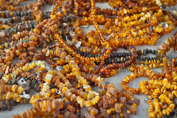 Necklace of colorful stones on the table. Many different jewelry and beads made of natural precious minerals. Amber jewelry is sold at the fair.