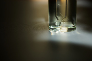 Cosmetic or medical glass bottle with pipette. Skin care concept. Natural hard light, deep shadows. - Image