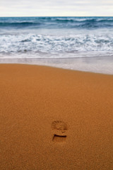Fototapeta na wymiar Summer sandy beach with footprint