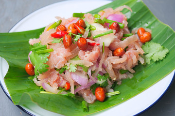 Thai traditional food fermented ground pork, fresh red and green chilli on fresh whole banana leaf