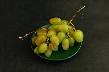     Green grapes on a black background        