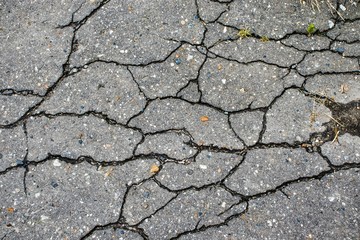 Background with old asphalt pavement in cracks