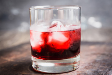 Old fashioned cherry cocktail with berries. Selective focus. Shallow depth of field. 