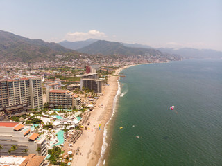 Fototapeta na wymiar Aerial photos of the pier knows as Playa Los Muertos pier in the beautiful town of Puerto Vallarta in Mexico, the town is on the Pacific coast in the state known as Jalisco