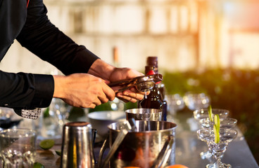 High ISO.The bartender with a cocktail is preparing a cocktail at the bar. Alcoholic beverages, people and luxury concepts.barman making cocktail at nightclub