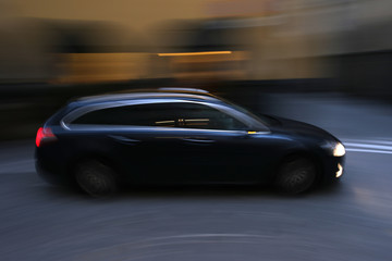 Fototapeta na wymiar dark car in motion