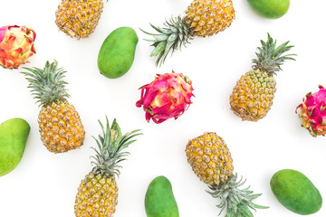 Fruit composition with pineapple, mango and dragon fruits on white background. Flat lay, top view
