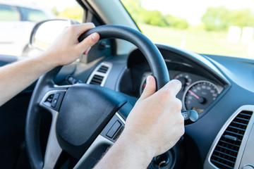 Naklejka premium the driver holds his hands on the steering wheel