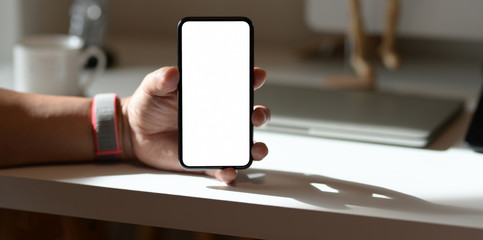 Close-up view of man showing his blank screen smartphone
